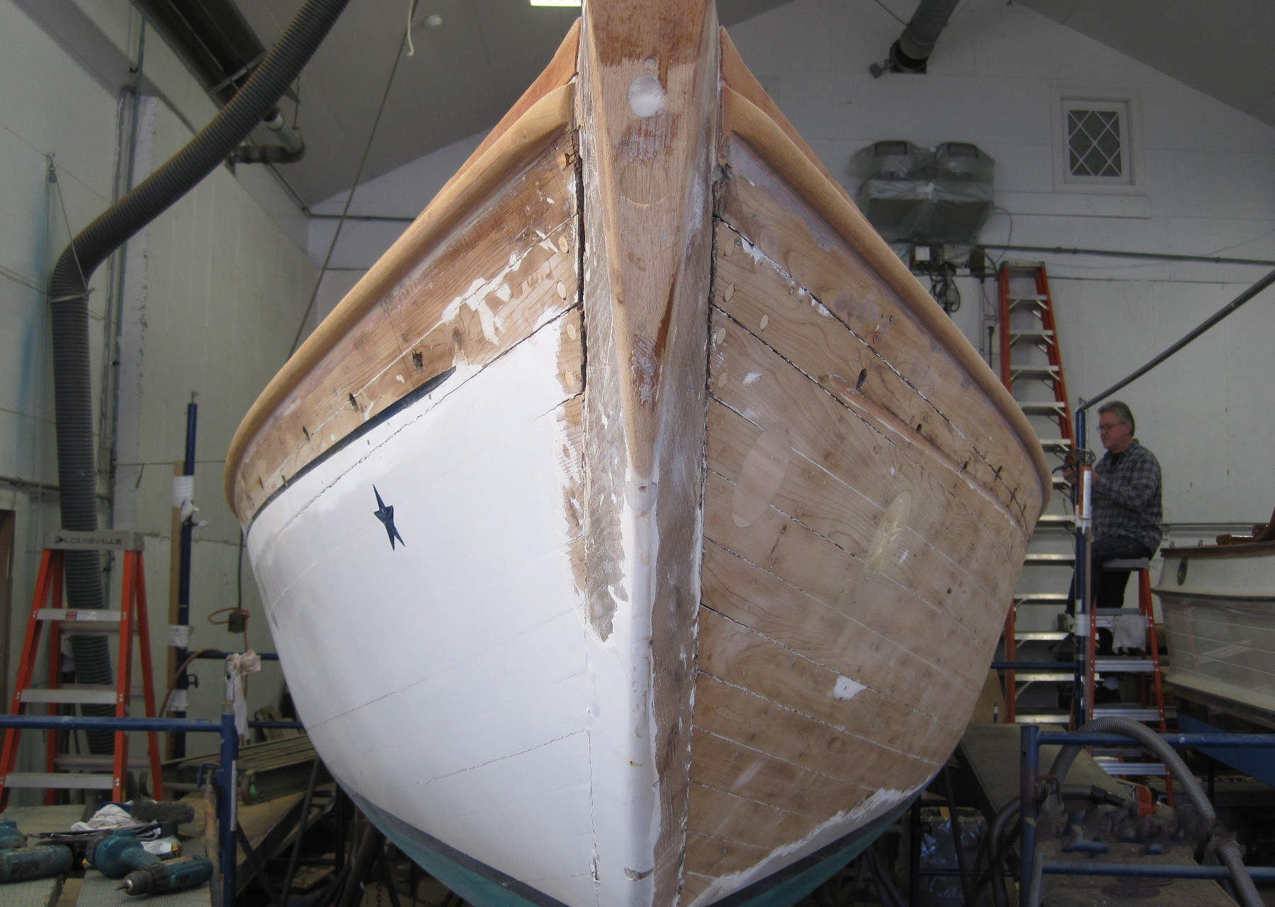 Wooden Boat Restoration - Kestrel - The hull being stripped for refastening and refinishing.
