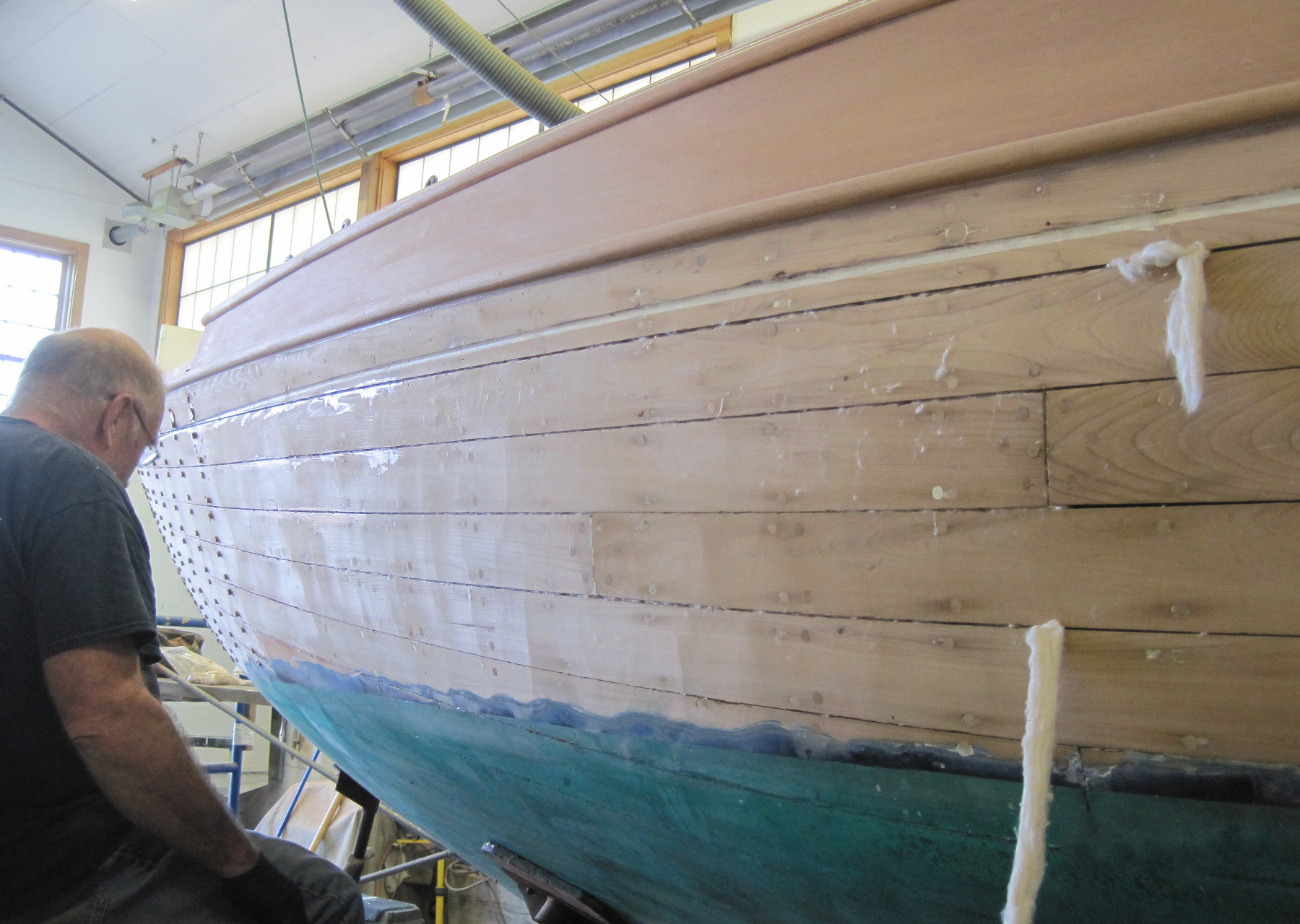 Wooden Boat Restoration - Kestrel - The hull planks being refastened and bunged.